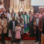 (Edmonton, AB) Faith leaders and representatives are joined by a family from Burkina Faso, where the 2024 resources were prepared, at St. Joachim’s Catholic Church. 